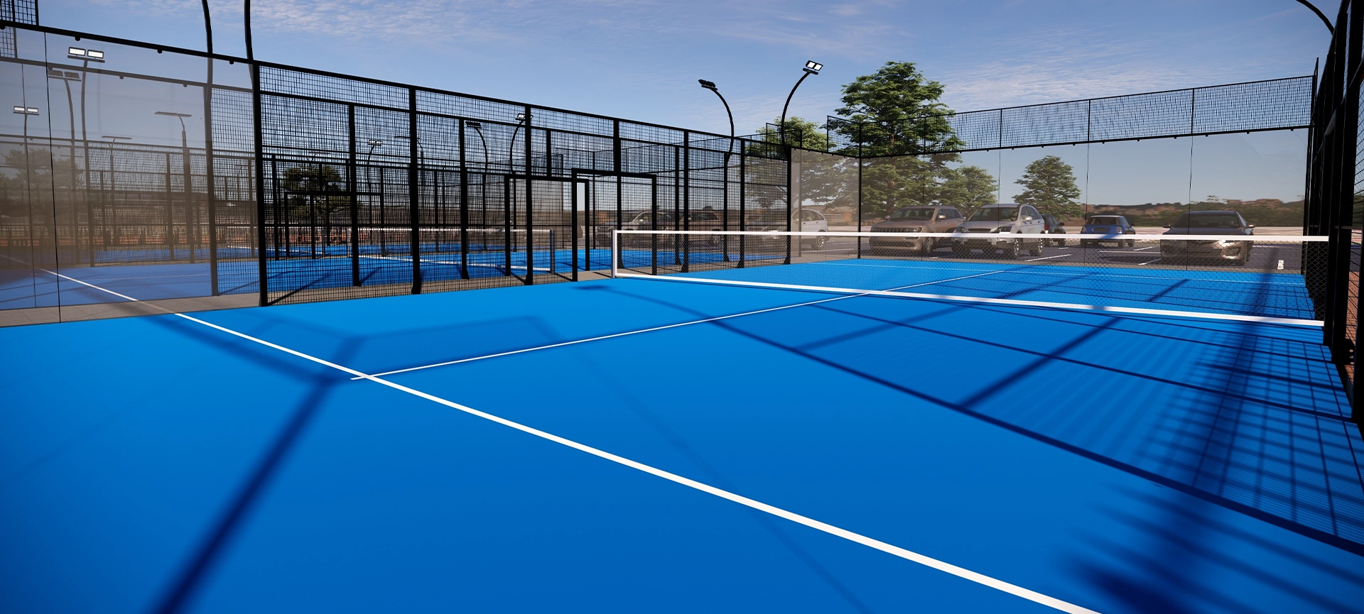 padel court outdoor with a blue surface, equipped with floodlights and glass