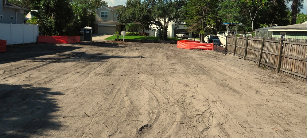 surface cleared for sport court installation in backyard space