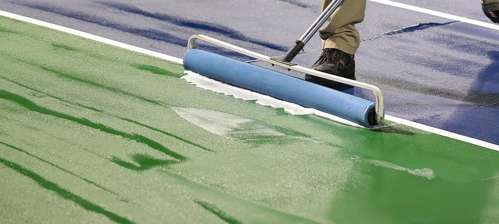 removing water from har-tru court surface using rollers