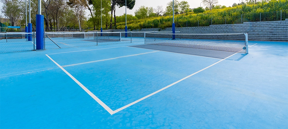 Sunny day in pickleball outdoors blue court with no people around