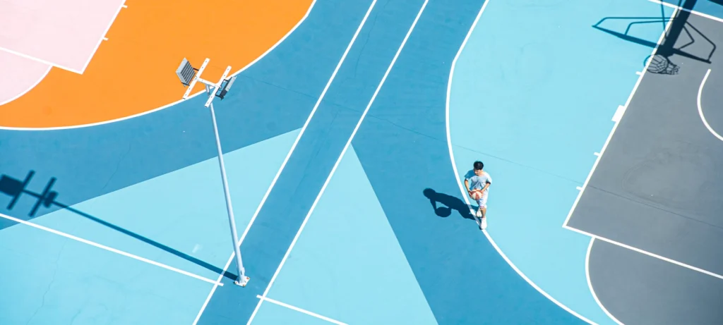 Young man playing basketball on court