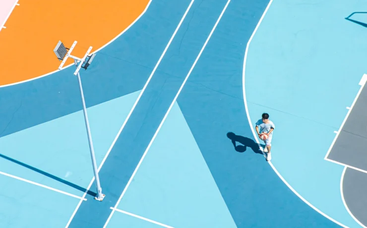 Young man playing basketball on court