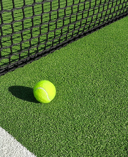 Ball Beside Tennis or Padel Net on Green Artificial Turf Court with White Line, Outdoor Sports Background with Copy Space