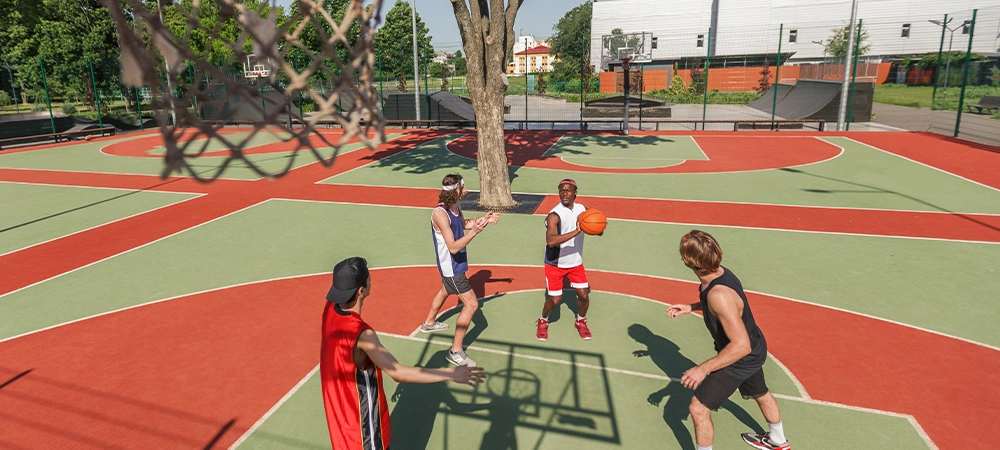 Above view of multiracial sports team playing basketball game at outdoor court