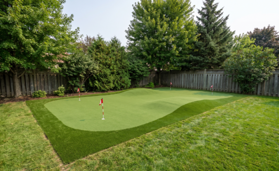 Finished backyard putting green with synthetic turf and gentle contours in an Ontario backyard