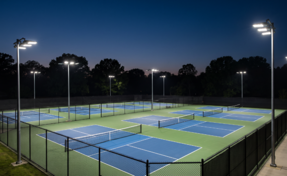 Outdoor tennis and pickleball courts lit by LED floodlights on poles at dusk in Ontario
